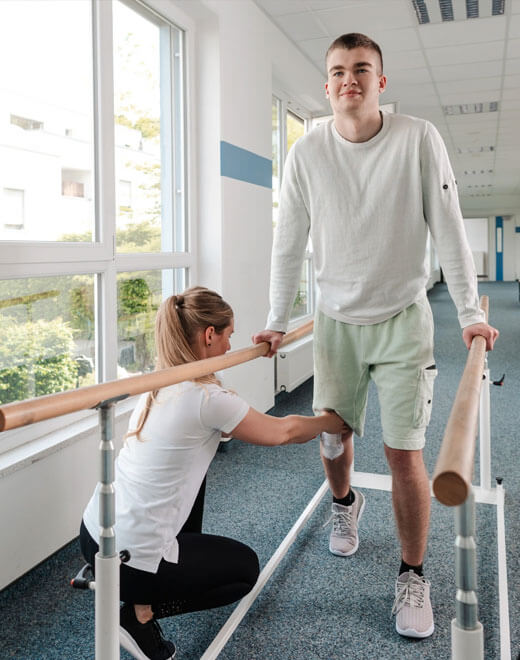 physio-helping-a-patient-walk-assisted.jpg