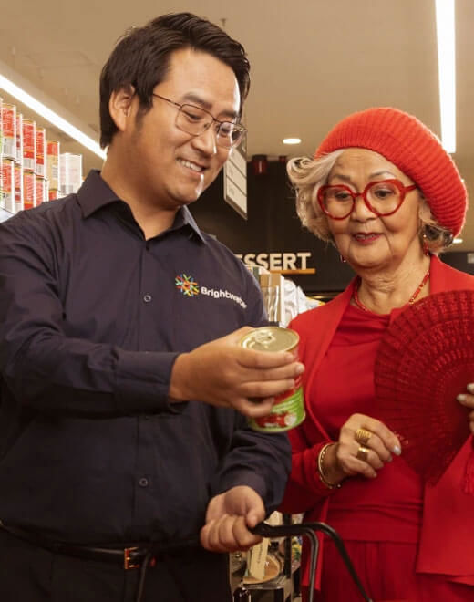 Brightwater care worker helping an elderly lady with her shopping