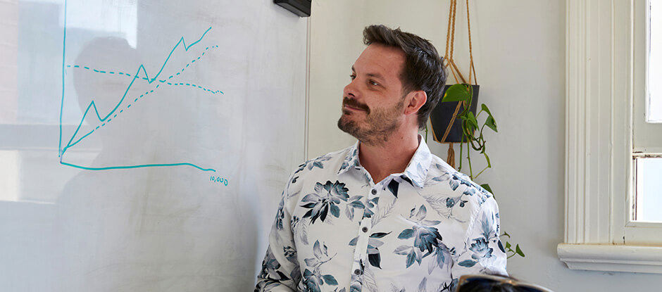 Jonathan Gilbert drawing a pretend graph on a whiteboard