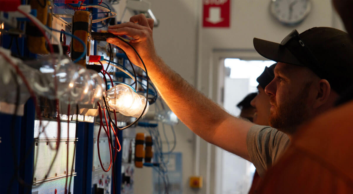 Male training to be an electrician by wiring