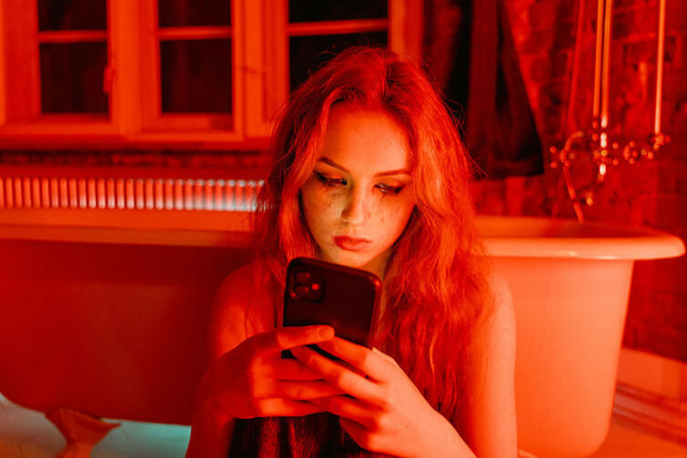 Young girl looking at her phone